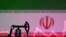 An illustration featuring an Iranian flag and an oil pump jack miniature model, Oct. 9, 2023. 