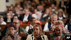 People wait Pope Francis inside the St. Elizabeth of Hungary Church in Budapest, Hungary, April 29, 2023. The Pontiff is in Hungary for a three-day pastoral visit.