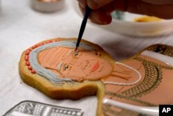 Jasmine Cho works on a portrait of Filipina mambabatok tattoo artist Apo Whang-Od in Pittsburgh, Pa., May 3, 2023. (AP Photo/Matt Freed)