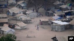 FILE - People stand by their houses in Juba, South Sudan, on Feb. 5, 2023, during a heatwave. A heatwave in March 2024 closed schools for two weeks, until the South Sudanese government said on March 26 that they would reopen next week.
