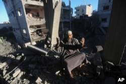 A Palestinian reacts after an Israeli strike on residential buildings in Rafah, Gaza, on Dec. 15, 2023.