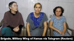 Israeli women, identified by Israeli Prime Minister Benjamin Netanyahu as Yelena Trupanob, Danielle Aloni and Rimon Kirsht, who are held captive by Hamas in Gaza, give a statement in this handout video grab obtained by Reuters, Oct. 30, 2023.