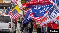 Supporters of former U.S. President Donald Trump gather for a loyalty rally at a busy intersection in Laguna Hills, California, U.S., March 21, 2023.