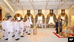 Thailand's Prime Minister Srettha Thavisin, center, leads, his cabinet members to take oath in front of Thailand's King Maha Vajiralongkorn, second right, and Thailand's Queen Suthida at Dusit Palace in Bangkok, Thailand, Sept. 5, 2023.