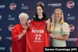 FILE - Indiana Fever's Caitlin Clark, middle, with general manager Lin Dunn, left, and head coach Christie Sides after a WNBA news conference, April 17, 2024, in Indianapolis. (AP Photo/Darron Cummings)