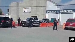 Police stand guard at their station in Ensenada, Mexico, May 2, 2024. Mexican authorities said that day that they had found tents and questioned people in the case of three tourists missing in Baja California. Three bodies were found in the area Friday.