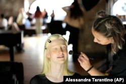 Lucia Della Ratta gets makeup during a photo shoot for "L'Imperfetta (The Imperfect) model agency" in Rome, Tuesday, Feb. 7, 2023.