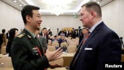 Chinese Defense Ministry spokesperson Wu Qian and Chad Sbragia, former Deputy Assistant Secretary of Defense for China at the Pentagon, chat at the Beijing Xiangshan Forum in Beijing, Oct. 30, 2023. 