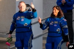 NASA astronauts Butch Wilmore, left, and Suni Williams leave the Operations and Checkout building before heading to the launch complex at the Cape Canaveral Space Force Station, Monday, May 6, 2024, in Cape Canaveral, Fla. (AP Photo/John Raoux)