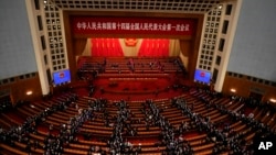 Delegates leave after the opening session of China's National People's Congress (NPC) at the Great Hall of the People in Beijing, March 5, 2023.