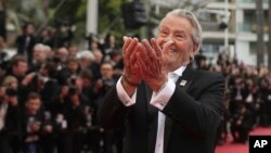 FILE - In this May 19, 2019, photo, French actor Alain Delon poses for photographers upon arrival at the premiere of the film 'A Hidden Life' at the 72nd international film festival, Cannes, southern France. 