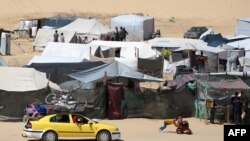Palestinos desplazados transportan sus pertenencias encima de un automóvil mientras huyen a una zona más segura en Rafah, en el sur de la Franja de Gaza, el 9 de mayo de 2024.