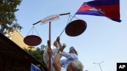 រូបឯកសារ៖ សកម្មជនសិទ្ធិមនុស្សរៀបចំតាំងជញ្ជីងយុត្តិធម៌ ក្នុងកម្មវិធីដើរហែក្បួនមួយដើម្បីអបអរសាទរខួប៧៥ឆ្នាំនៃទិវាសិទ្ធិមនុស្សអន្តរជាតិ នៅរាជធានីភ្នំពេញ កាលពីថ្ងៃទី១០ ខែធ្នូ ឆ្នាំ២០២៣។