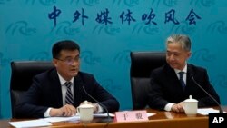 Deputy Director of Department of Eurasia of Ministry of Foreign Affairs Yu Jun, left, speaks with Chinese Foreign Ministry spokesperson Wang Wenbin after a news conference in Beijing, Wednesday, April 26, 2023. (AP Photo/Andy Wong)