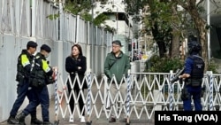 押送李宇軒的囚車進入西九龍裁判法院大樓時，警方暫時封鎖附近的行人路，甚至有荷槍實彈的反恐特勤警員戒備。(美國之音 湯惠芸)