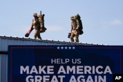 Security gets in position before Republican presidential nominee former President Donald Trump speaks at a rally, in Asheboro, North Carolina, Aug. 21, 2024.