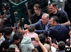 Turkey's President Recep Tayyip Erdogan with supporters at a polling station, in Istanbul, Turkey, May 14, 2023.