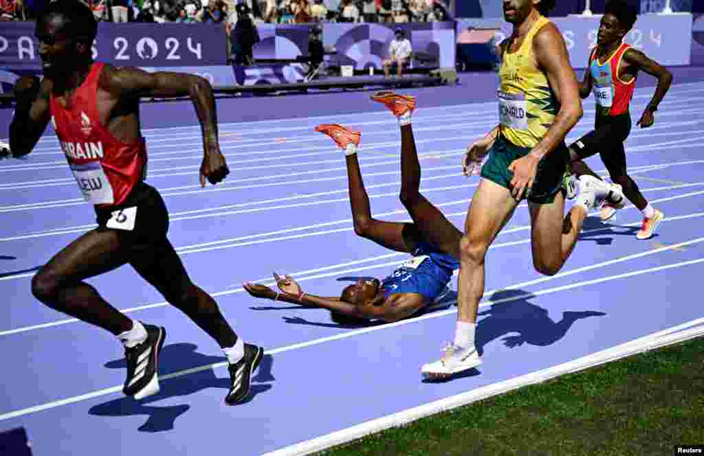 Abdihamid Nur of United States falls in the athletics men's 5,000m round 1 competition during the Paris 2034 Olympics in Saint-Denis, France.