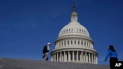 ARCHIVO - Visitantes caminan fuera del edificio del Capitolio de Estados Unidos en Washington, el 27 de mayo de 2023.