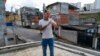 FILE - Influencer Murilo Duarte streams a live video at the Jardim João XXIII slum in Sao Paulo, Brazil, on April 19, 2023. 