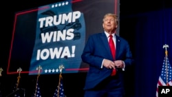 Republican presidential candidate and former President Donald Trump takes the stage at a caucus night party in Des Moines, Iowa, Jan. 15, 2024.