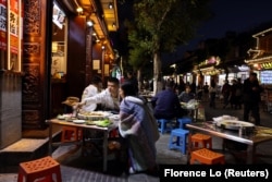 Customers dine at a restaurant in the old town of Dali, Yunnan province, China November 9, 2023. (REUTERS/Florence Lo)