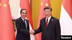Presiden China Xi Jinping dan Presiden Joko Widodo berjabat tangan saat upacara penyambutan di sela-sela Konferensi Tingkat Tinggi Inisiatif Sabuk dan Jalan (BRI), di Beijing, China, 17 Oktober 2023. (Foto: China Daily via REUTERS)