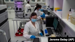 FILE - Scientists conduct reserach at an Afrigen Biologics and Vaccines facility in Cape Town, South Africa, Tuesday Oct. 19, 2021. (AP Photo/Jerome Delay, File)