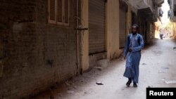 Mamadou Safaiou Barry, a 25-year-old from Guinea, walks to the center where he studies Islam and the Koran, in El Marg district, east of Cairo, Egypt, September 23, 2023. (REUTERS/Fatma Fahmy)
