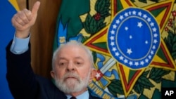 Brazil's President Luiz Inacio Lula da Silva gives a thumbs-up sign during a breakfast with journalists at Planalto presidential palace in Brasilia, Brazil, Oct. 27, 2023.