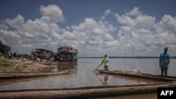 Des pêcheurs rentrent après une journée de travail sur le fleuve Congo, à quelques kilomètres de la ville de Kisangani, province de la Tshopo, Nord-est de la RDC, le 01 septembre 2022.