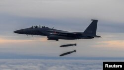 A South Korean Air Force F-15K fighter jet takes part in a joint bombing drill with U.S. in this handout picture provided by the Defense Ministry, South Korea, Oct. 4, 2022.