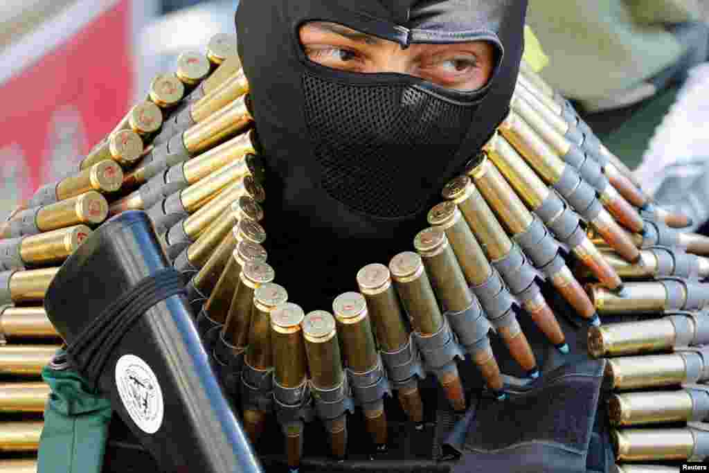 An armed man attends the funeral of Abdul Rahman Khazem, a Palestinian gunman and another man Muhammad Abu Naasa, who were killed by Israeli forces in a raid, in Jenin in the Israeli-occupied West Bank.
