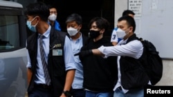 FILE - Founder of the Student Politicism group Wong Yat Chin is detained by police, in Hong Kong, Sept. 20, 2021. 
