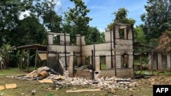 This handout photo shows a civilian building destroyed after being landmined and burned down by the Myanmar military, according to the rights group, in Daw Ngay Ku village in Hparuso township, in eastern Myanmar's Kayah state. (Photo by Handout / Amnesty International / AFP)