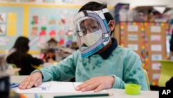 FILE - A student wears a mask and face shield in a 4th grade class amid the COVID-19 pandemic at Washington Elementary School on Jan. 12, 2022. (AP Photo/Marcio Jose Sanchez, File)