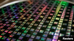 FILE - A 12-inch wafer is displayed at Taiwan Semiconductor Manufacturing Company (TSMC) in Xinchu, Jan. 9, 2007.