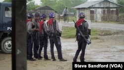 Border Guard Police stand at edge of Sittwe IDP camp in August 2017, a few days after the start of the clearance operation.
