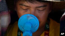 FILE - A man cools off from the intense heat in Lisbon, Portugal on Aug. 6, 2023. UN weather agency says Earth had the hottest summer ever in the northern hemisphere. (AP Photo/Armando Franca, File)