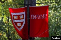 FILE - Banners for Harvard Law School fly in Cambridge, Massachusetts, U.S., October 5, 2018. Harvard and many American colleges have strict rules regarding copyright and plagiarism. (REUTERS/Brian Snyder/File Photo)