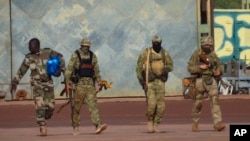 This undated photograph handed out by French military on Jan. 6, 2022, shows three Russian mercenaries, right, in northern Mali. (French Army via AP)