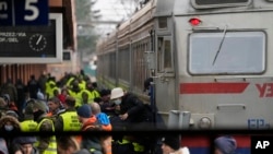 Displaced persons fleeing Russia's invasion of Ukraine crowd a platform at the train station in Przemysl, Poland, March 3, 2022. 