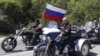 FILE - Russia's Prime Minister Vladimir Putin, foreground, rides a Harley-Davidson Lehman Trike 
