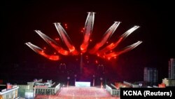 Planes perform an aerial display during a nighttime military parade to mark the 90th anniversary of the founding of the Korean People's Revolutionary Army in Pyongyang, North Korea, in this undated photo released by North Korea's Korean Central News Agenc