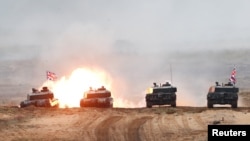 FILE - British Army Challenger 2 tank fires during NATO enhanced Forward Presence battle group Iron Spear 2019 exercise in Adazi, Latvia October 11, 2019. 
