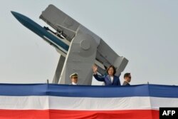 Taiwan's President Tsai Ing-wen (C) waves to assembled guests from the deck of the 'Ming Chuan' frigate during a ceremony to commission two Perry-class guided missile frigates from the US into the Taiwan Navy, in the southern port of Kaohsiung on November 8, 2018.