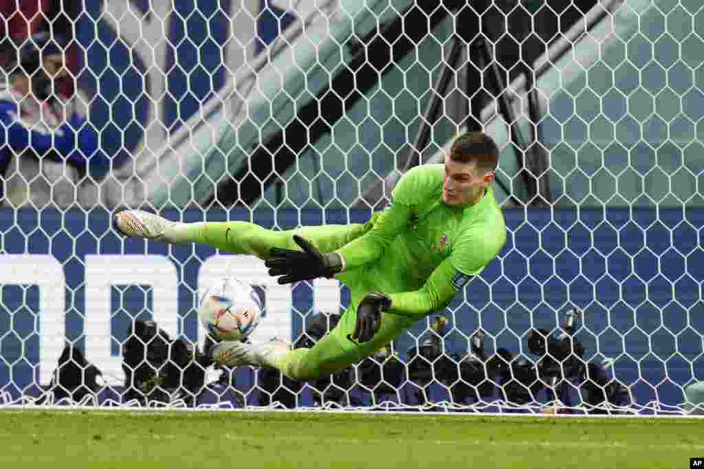 Croatia's goalkeeper Dominik Livakovic makes a save during the penalties shootout during the World Cup round of 16 soccer match between Japan and Croatia at the Al Janoub Stadium in Al Wakrah, Qatar.&nbsp;Croatia won a penalty shootout 3-1 to qualify for the next round.