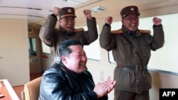 This picture taken March 24, 2022, and released from North Korea's official Korean Central News Agency on March 25, shows North Korean leader Kim Jong Un, center, reacting to a test launch of a new inter-continental ballistic missile in an undisclosed location in North Korea.