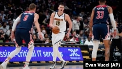 Nikola Jokić, Kristaps Porzingins (levo) i Kajla Kuzma (desno) na meču Vašington Vizardsa i Denver Nagetsa, 16. marta 2022. u Vašingtonu (Foto: AP/Evan Vucci) 