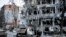 FILE - Damaged vehicles and buildings in Kharkiv city center in Ukraine, March 16, 2022. 